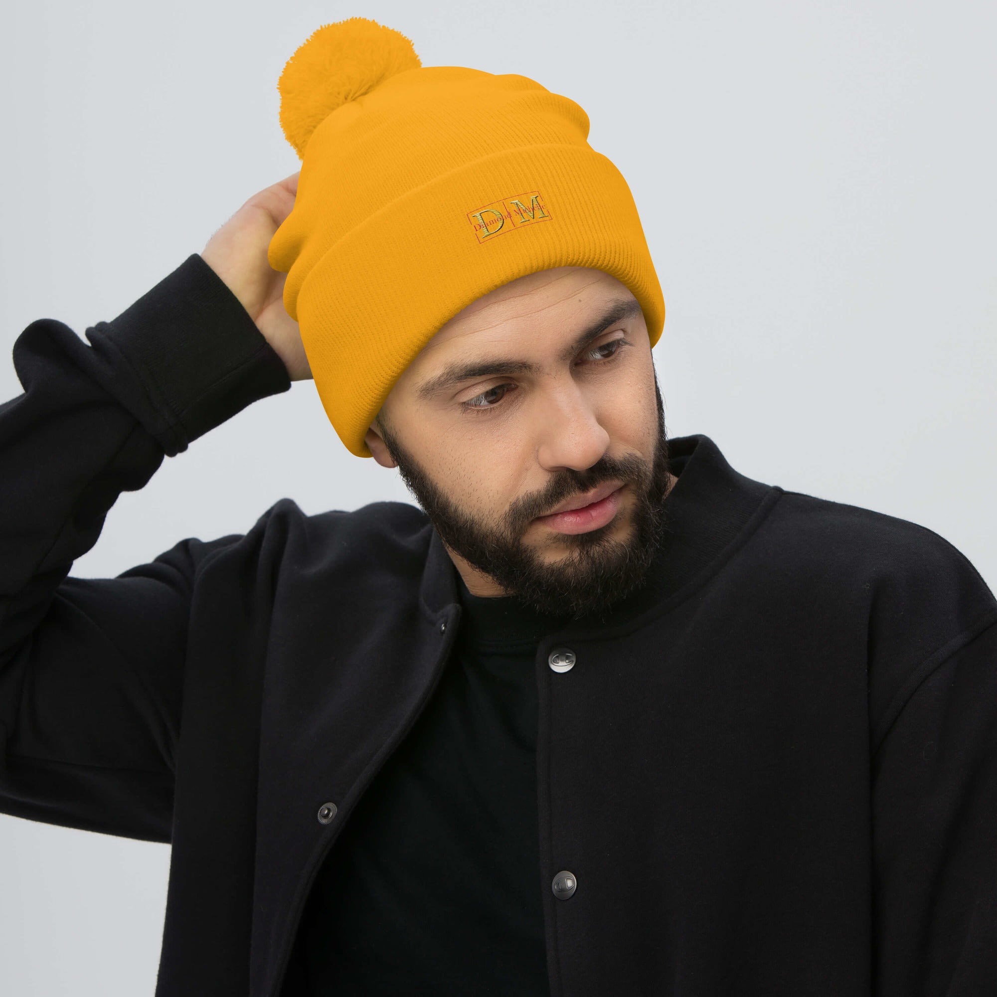 Man wearing a gold DM Pom-Pom Beanie front view