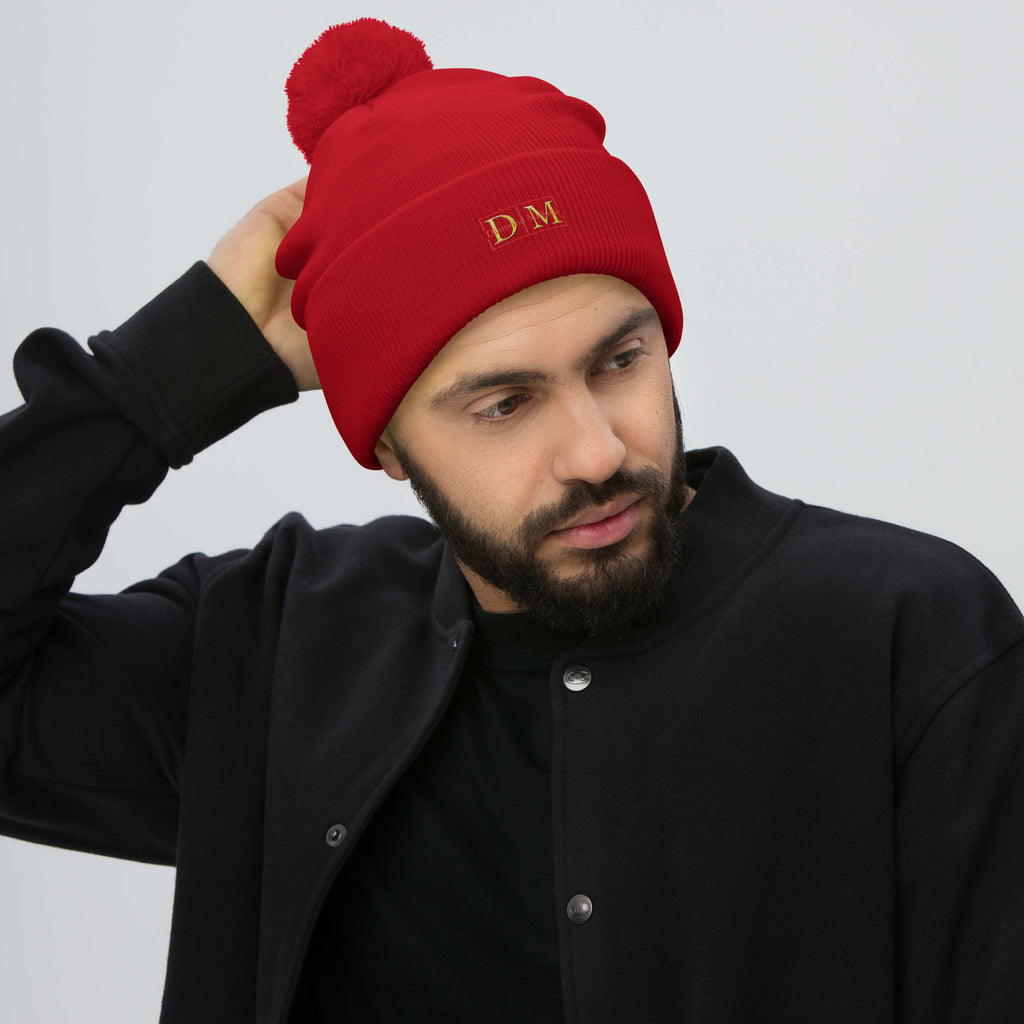 Man wearing a red DM Pom-Pom Beanie front view