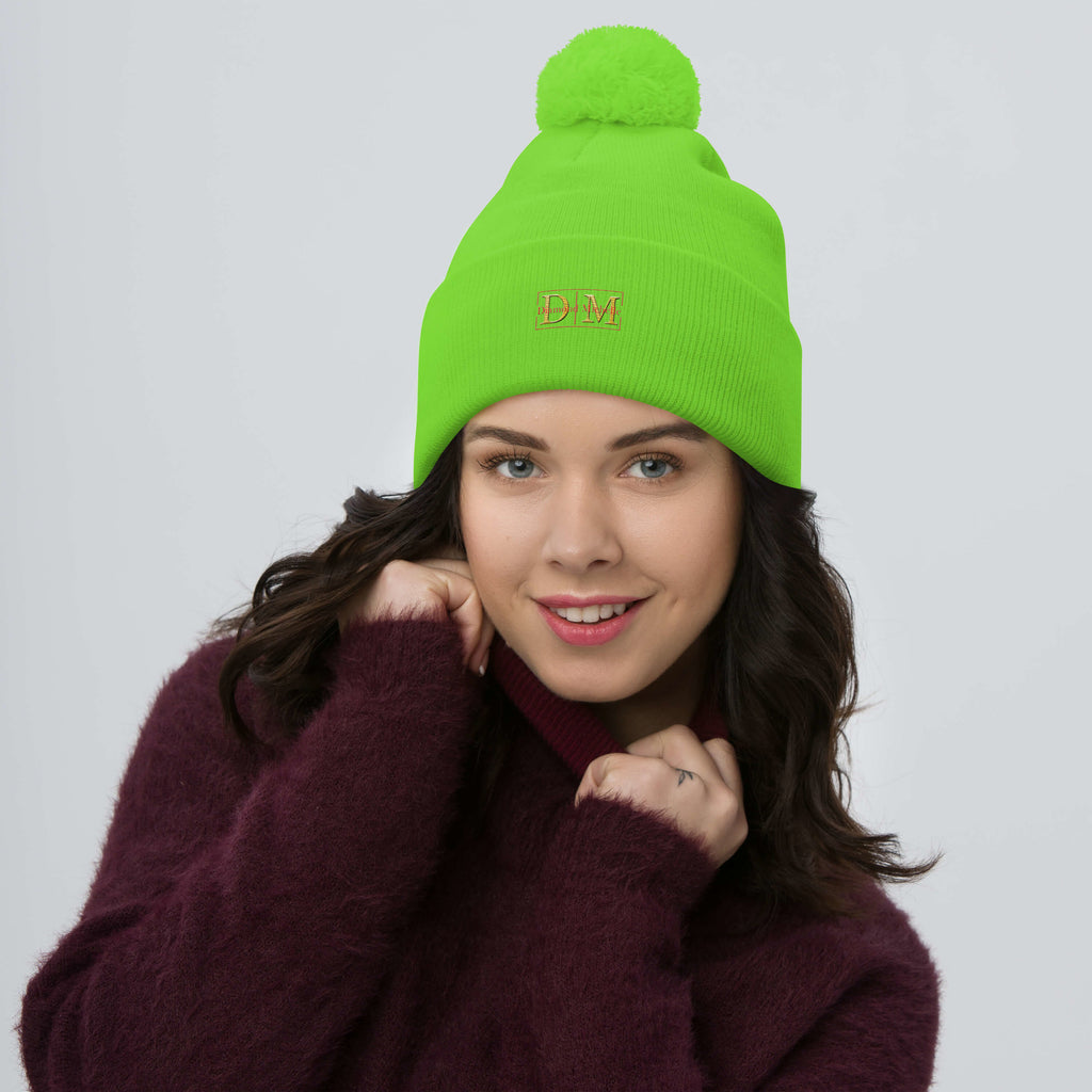 Woman wearing a neon green DM Pom-Pom Beanie front view
