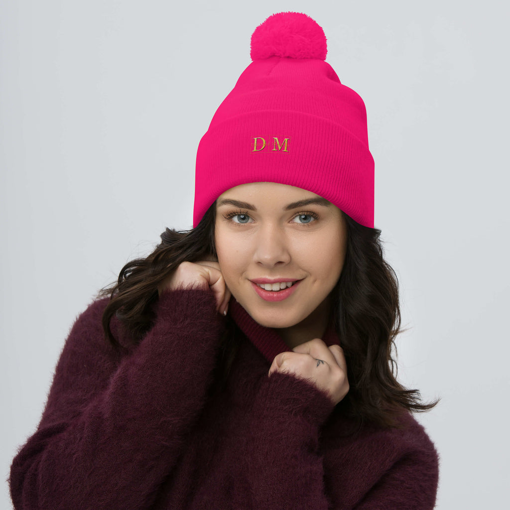 Woman wearing a neon pink DM Pom-Pom Beanie front view