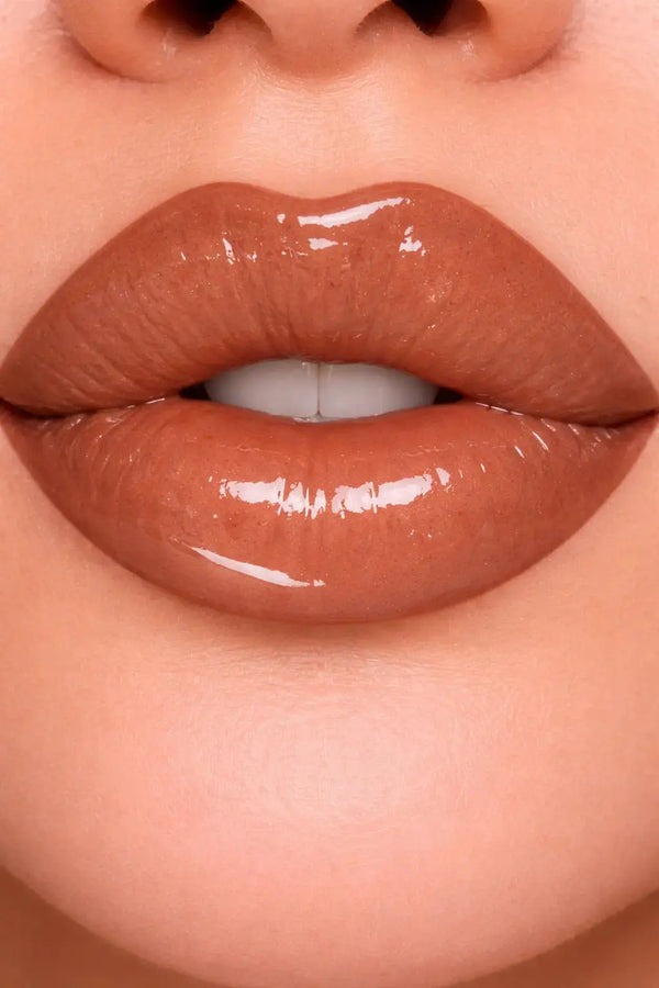 Close-up of glossy brown lips with a neutral background