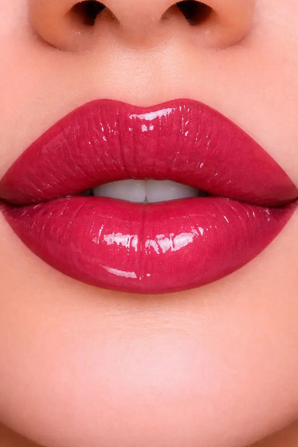 Close-up of glossy huckleberry pie diamond glow lip oil on lips