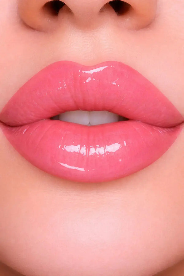 Close-up of glossy pink lips with a soft focus background