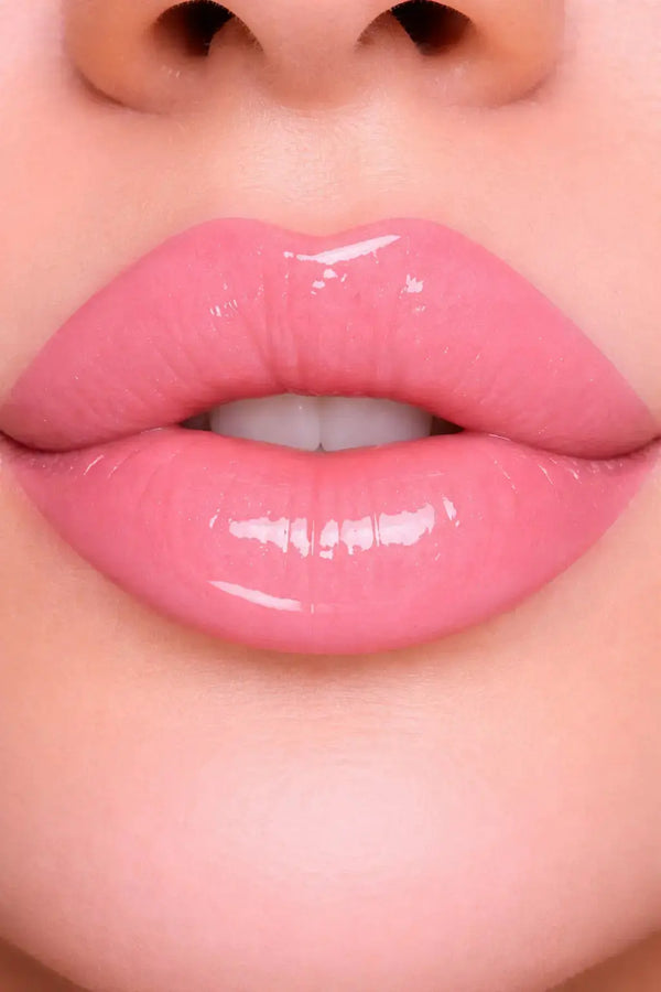 Close-up of glossy pink lips with a blurred background