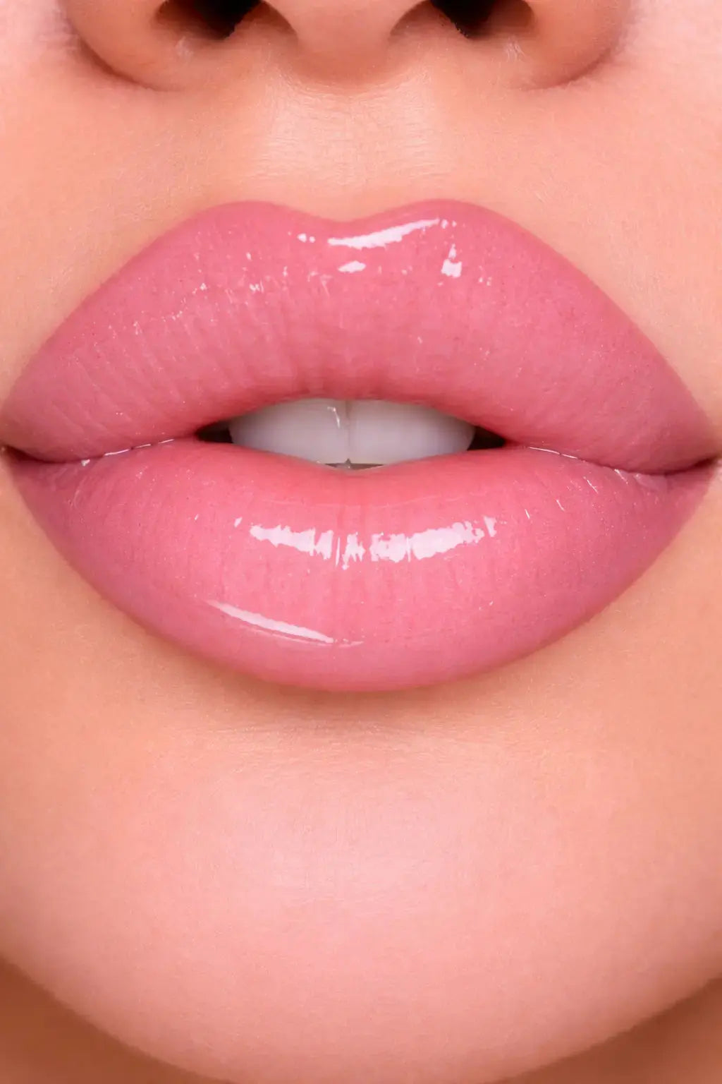 Close-up of glossy pink lips with a blurred background
